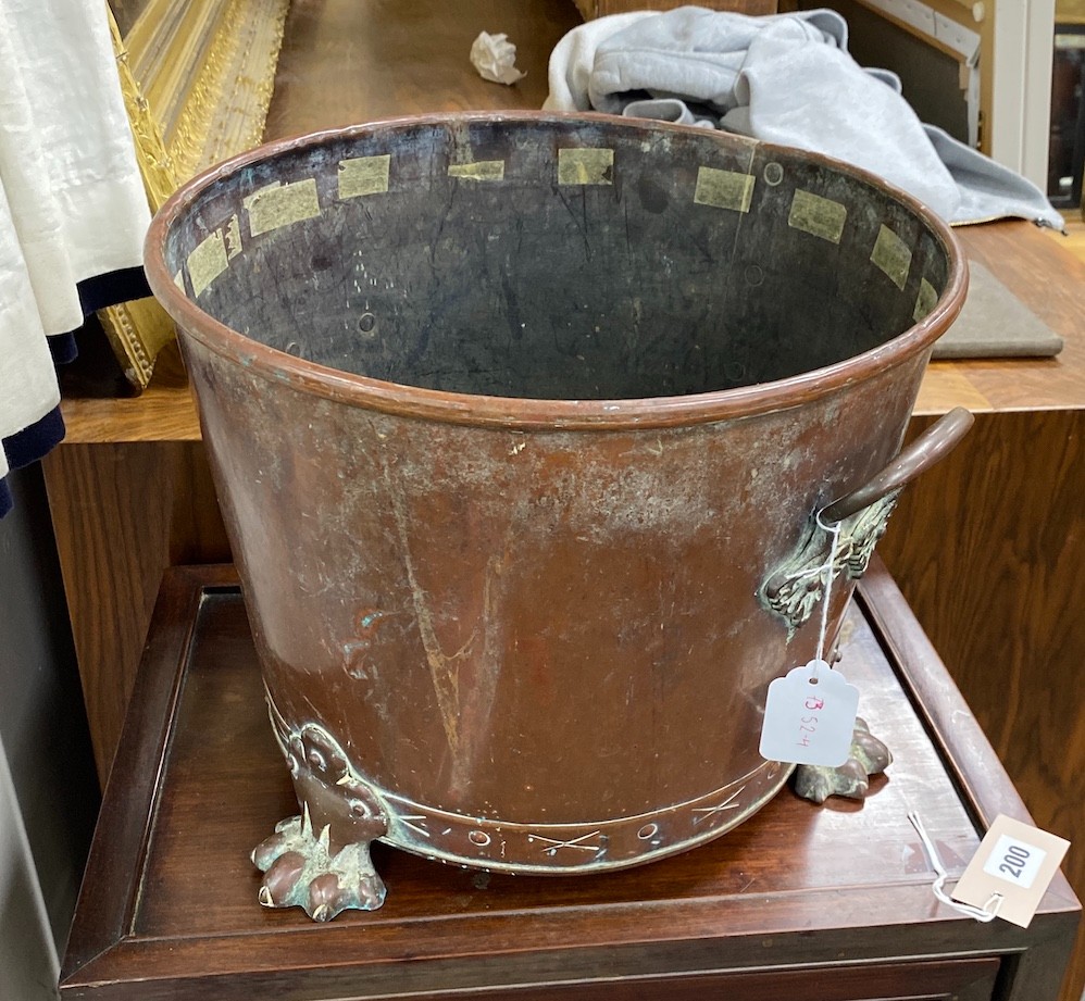 An early 20th century two handled copper log bin on lion's paw feet, diameter 35cm, height 28cm